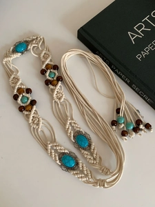 Detailed close-up of Bohemian wax rope waist chain with wooden beads and turquoise accents