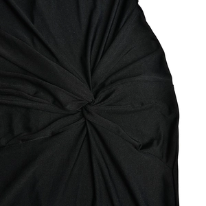 Detailed macro view of the elegant black twisted knot design on this slim fit maxi dress