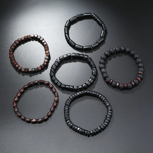 Detailed flat lay of six handmade beaded bracelets with wood and black volcanic stone