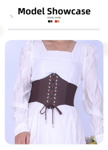 Close-up of vintage dark brown lace-up corset belt with metal eyelets and elastic band