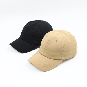 Close-up of black and khaki cotton twill baseball caps with breathable eyelets