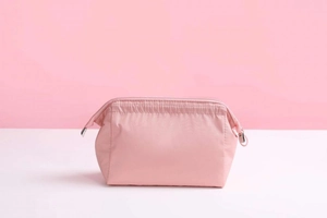 Close-up of pink waterproof nylon cosmetic bag with metal zipper and durable square structure