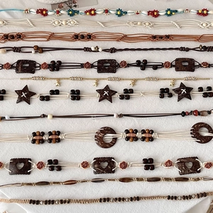 Detail of bohemian hand-woven belts with colorful beads and vintage wooden textures