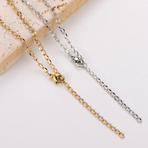 Close-up of gold and silver plated curb chains with lobster clasps and extension links