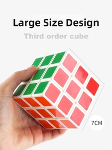 Detail shot of a 7CM large white 3x3 speed cube held in hand for size comparison