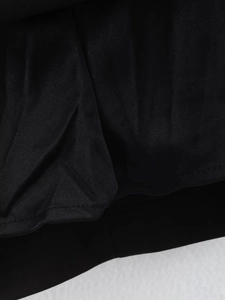 Close-up macro detail of premium black fabric material with uniform stitching and texture