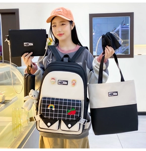 Close-up of stylish 5-piece black and white school backpack set with cute accessories