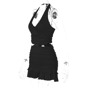 Detail of black knit two-piece set featuring halter neck top and ruffled mini skirt details