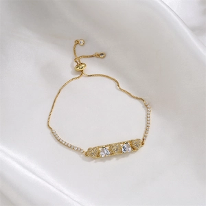 Macro detail of adjustable gold heart bracelet with pear-cut cubic zirconia accents