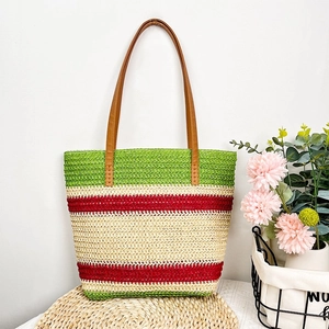 Detail of handwoven striped beach tote bag with durable brown leather shoulder straps