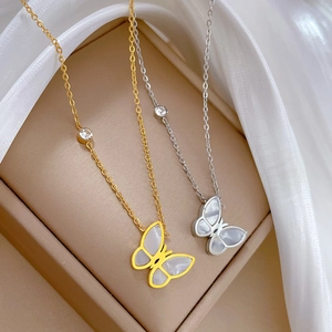 Minimalist gold and silver butterfly necklaces with mother of pearl in a jewelry box