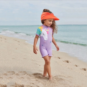 Close-up of kids purple short sleeve unicorn swimsuit with orange sun visor hat