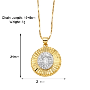 Macro shot of gold sunburst pendant showing 24mm x 21mm dimensions and fine gemstone inlay