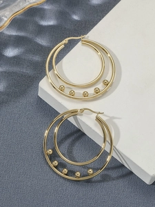 Detailed view of gold stainless steel double hoop earrings with five metal beads
