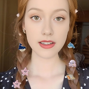 Colorful sea animal hair clips with whale, octopus and shell shapes on braided hair