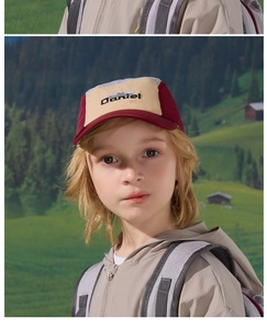 Close-up of children outdoor cap with mountain embroidery and color-block windbreaker