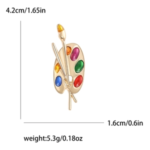 Vintage gold palette and paintbrush brooch with colorful gemstones and size indicators