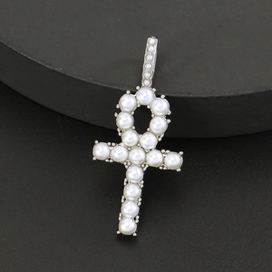 Macro shot of silver Ankh cross pendant with white pearls on black display