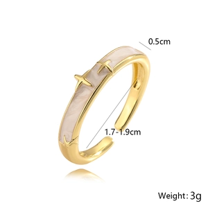 Detailed view of adjustable gold ring with cream enamel and star studs showing dimensions