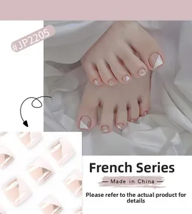 Detail of French style press-on toenails with white slanted edges and gold glitter