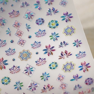 Holographic floral nail art stickers with mandala and geometric designs on white background
