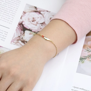 Detail of gold beaded bracelet with Palestine flag map pendant worn by a model