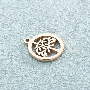 Macro shot of gold-plated hollow Tree of Life charm in stainless steel for jewelry making