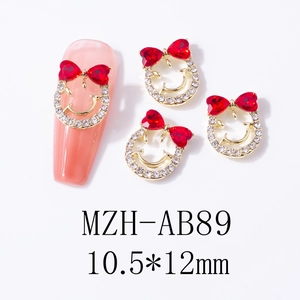 Macro detail of red heart bow nail charm with gold base on a pink manicure