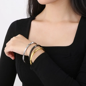 Three-piece minimalist Möbius cuff bracelets in gold, silver and black stainless steel