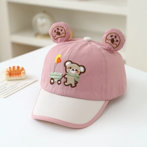 Detailed embroidery of a bear on a pink baby baseball cap with soft cotton texture