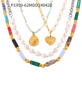 Multi-layered gold necklace set with natural stones, pearls, and heart pendants detail