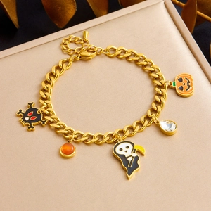 Detail of Halloween gold bracelet with skull, grim reaper, pumpkin and enamel charms