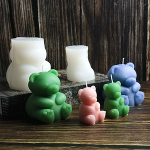 Detailed view of DIY teddy bear silicone candle molds with colorful wax finished bears