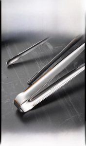 Detailed macro of SUS 304 stainless steel food tongs with serrated grip and brushed finish