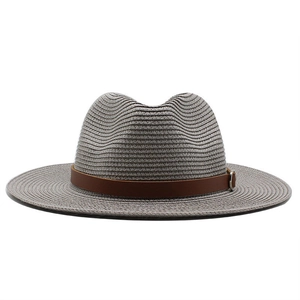 Close-up of grey woven straw fedora hat featuring a brown leather band and silver buckle