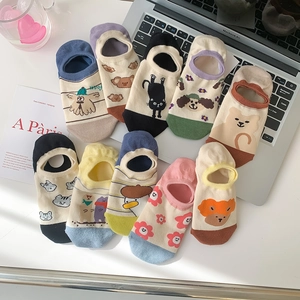 Set of 10 minimalist graffiti boat socks with colorful cartoon animal patterns on desk