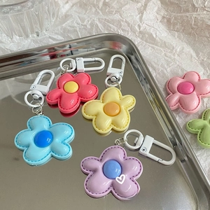 Detailed stitching on colorful sunflower leather keychains with white metal clasps