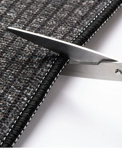 Close-up of dark grey kitchen mat edge showing durable lock-stitch and texture details