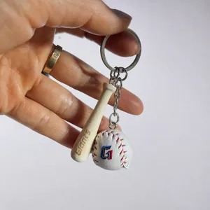 Macro detail of a 2CM baseball keychain featuring a mini wooden bat and leather stitched ball