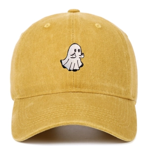 Detail of white ghost embroidery on mustard yellow washed cotton baseball cap texture