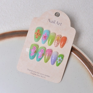 Detail of floral press-on nails with 3D petal relief and pastel gradient finish