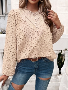 Detailed close-up of beige hollow lace embroidery and puff sleeves on long sleeve top