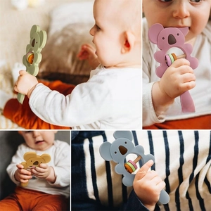 Close-up of food-grade silicone koala teether with wooden rings for baby sensory play