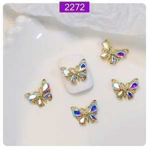 Macro detail of 3D crystal butterfly nail art charm with aurora rhinestones on white tips