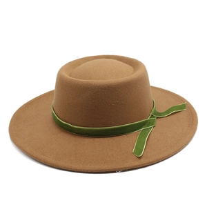 Close-up of tan wool fedora with olive green velvet ribbon and elegant side knot detail