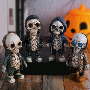 Set of four stylish skull figurines in colored hoodies for Halloween table decoration
