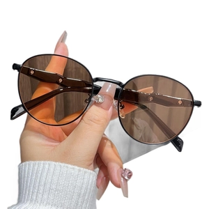 Retro round metal sunglasses with translucent brown lenses and sleek black frames