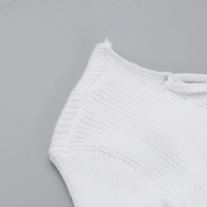 Detailed macro view of the fine ribbed knit fabric and stitching on a white slim dress