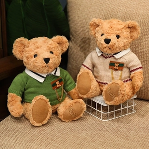 Cute teddy bears in green and cream knitted sweaters on a warm cozy sofa