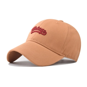 Close-up of red Vintage 3D embroidery on khaki cotton twill baseball cap fabric